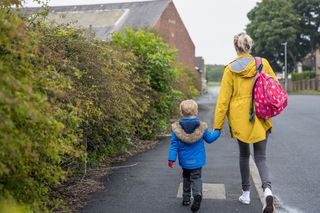 mother walking child to school