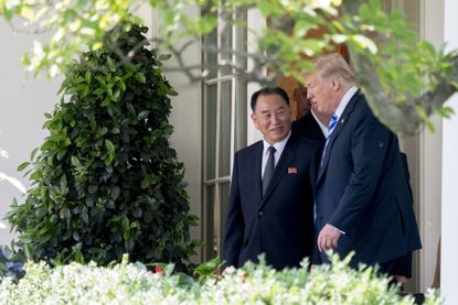 President Donald Trump talks with Kim Yong Chol, former North Korean military intelligence chief and one of leader Kim Jong Un's closest aides, as they walk from their meeting in the Oval Off