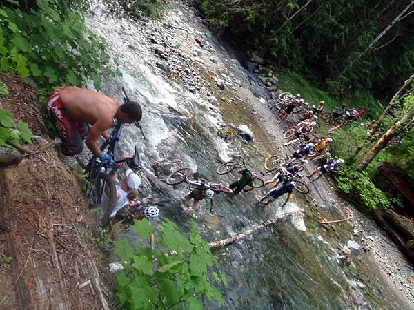 A steady stream of racers forges through the river.