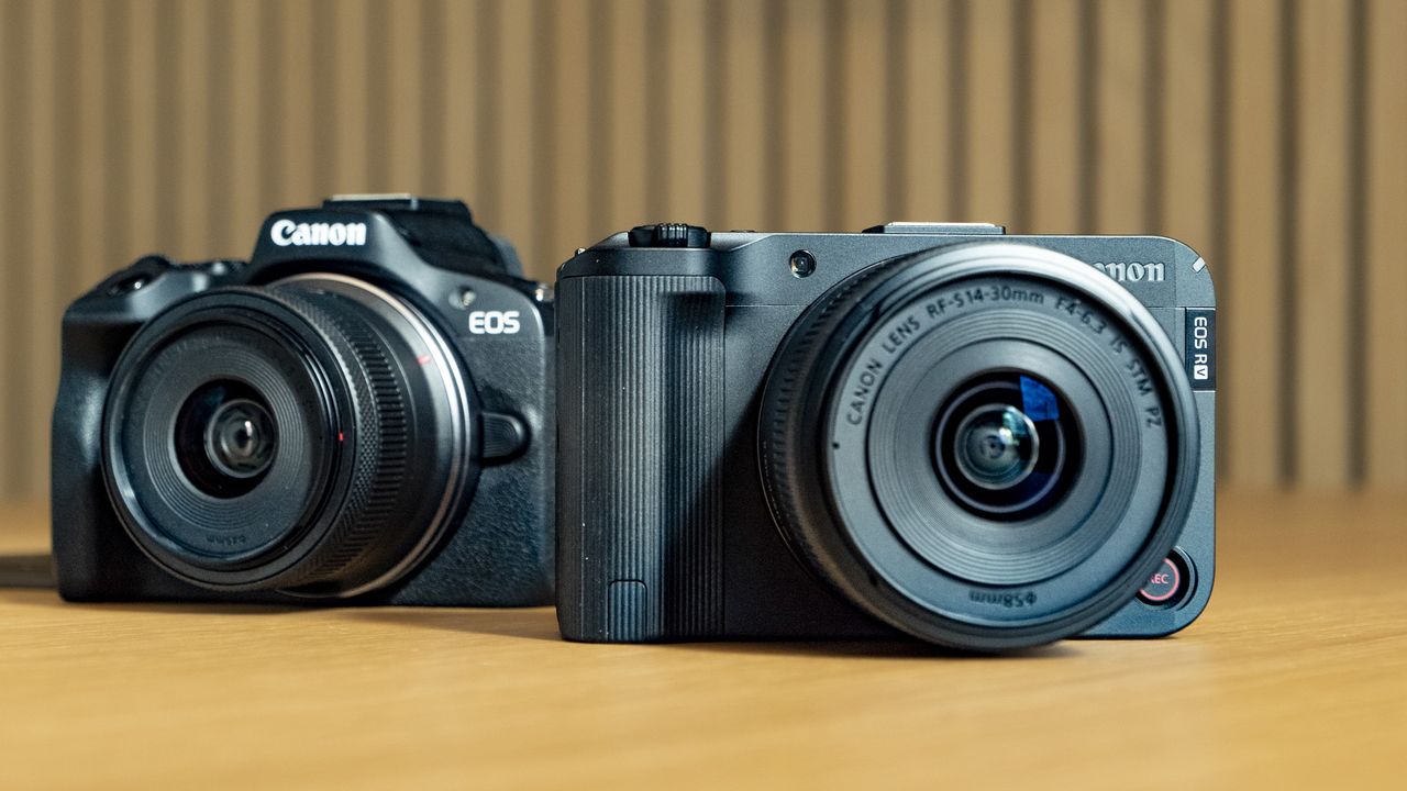 Canon EOS R50 V on a wooden table, alongside the EOS R50