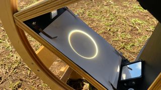 a ring of light projected onto a white screen of paper.