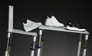 Black & White- Three Rucoline trainers in a line placed on a tilted chair and table