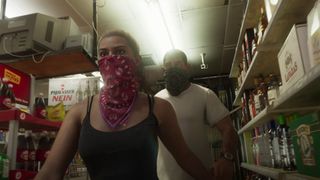 Grand Theft Auto 6 screenshot showing protagonist Lucia and a male character walking through a store