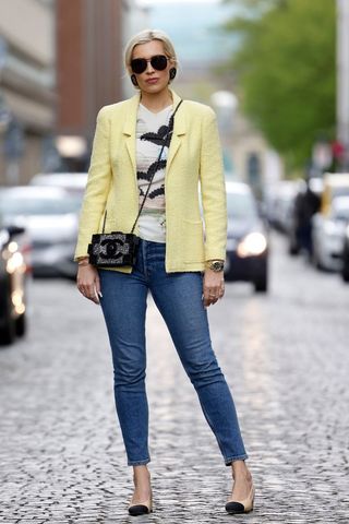 A woman wearing Chanel heels and skinny jeans