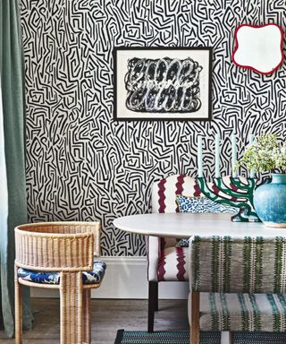 Rattan dining chair, black ands white wallpaper, candelabra