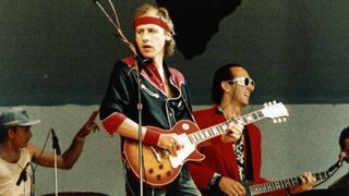 Photo of Mark KNOPFLER and DIRE STRAITS and LIVE AID and Jack SONNI, Mark Knopfler (playing Gibson Les Paul guitar) and Jack Sonni performing live onstage at Live Aid