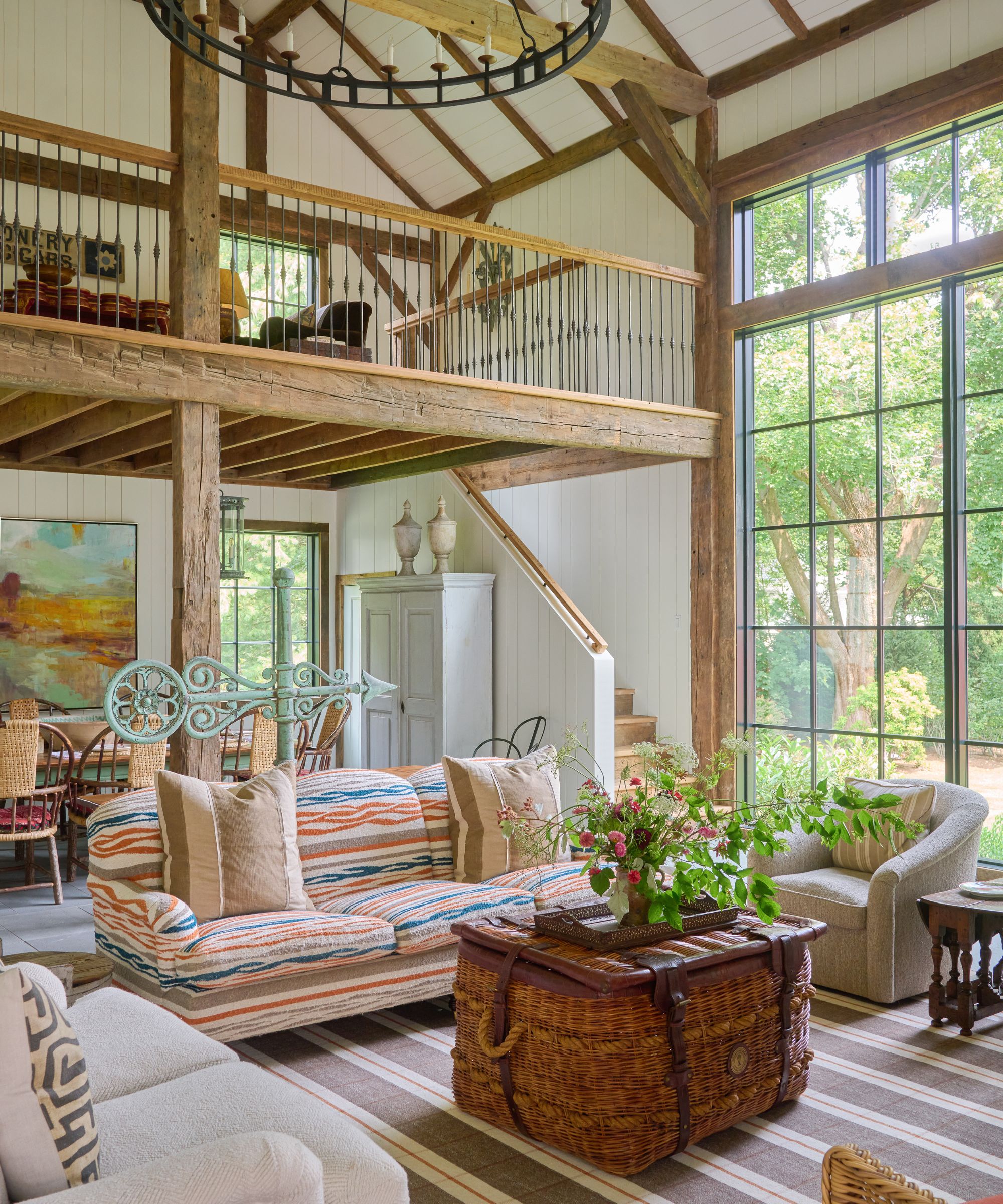 Living room with mezzanine level, striped rug and vintage furniture