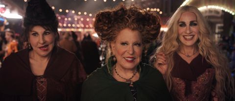 Kathy Najimy, Bette Midler, and Sarah Jessica Parker appear as The Sanderson Sisters at a Halloween carnival in Hocus Pocus 2.