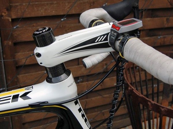 A white Bontrager Race XXX Lite carbon road stem clamps on to an aluminum Bontrager handlebar.