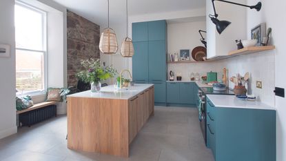 Blue kitchen with slab doors and oak island