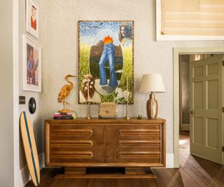 Console table with abstract art hanging above