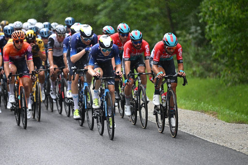 Riders from Movistar and Lotto Dstny line up at the front of the peloton