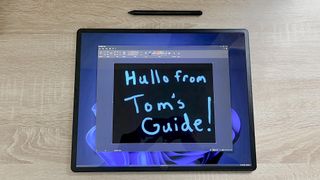 Lenovo ThinkPad X1 Fold 16 review unit on desk with stylus nearby