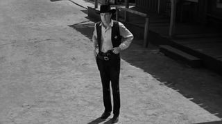 Gary Cooper stands in a frontier town in High Noon