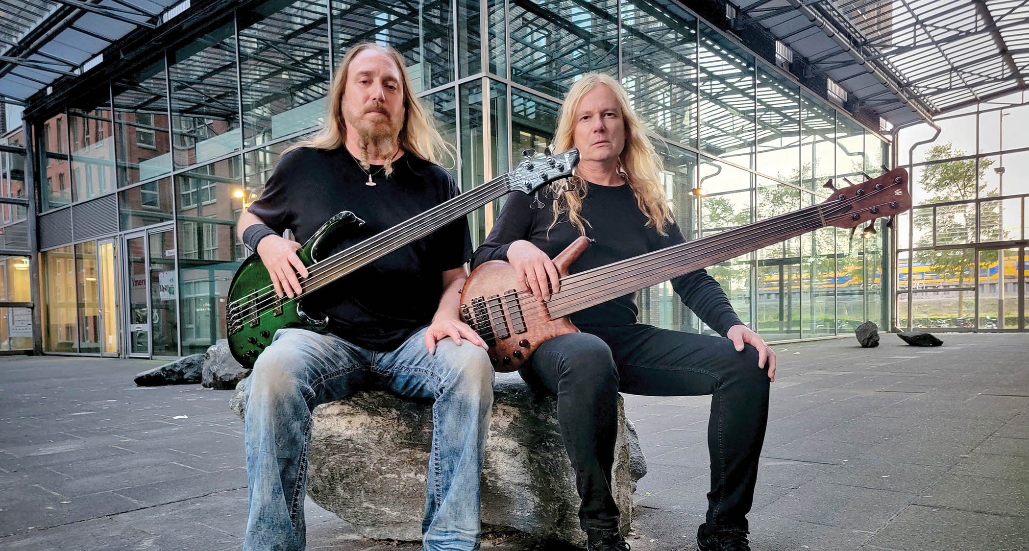 Bass legends Steve DiGiorgio and Jeroen Paul Thesseling pose with their fretless basses in this promo pic for new fusion project Quadvium