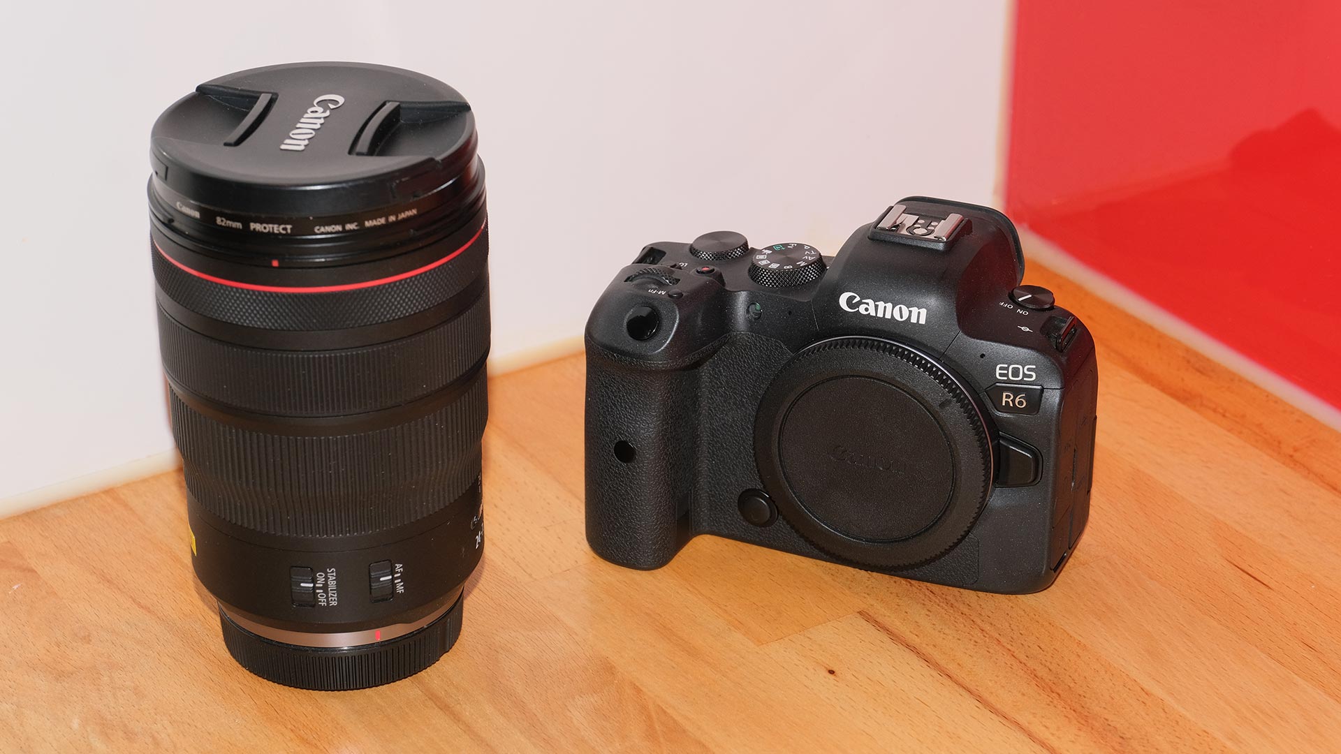 The Canon EOS R6 full-frame mirrorless camera. This shot shows it from the front, with the 27-70mm lens next to it