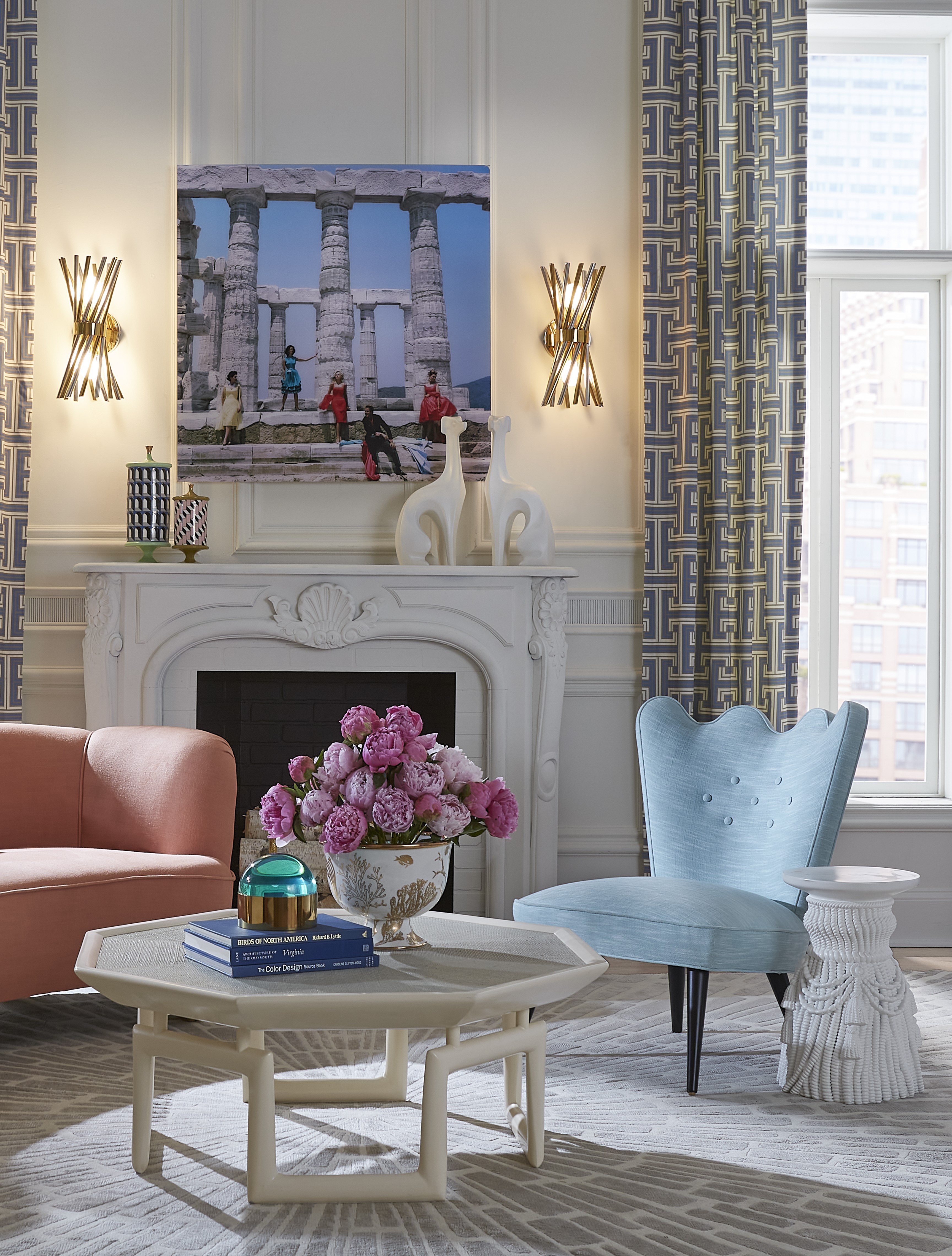 Jonathan Adler's "Giant Tassel Stool" pictured alongside pastel furniture in an opulent living room.