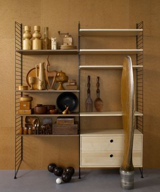 a wood and black metal shelving unit with drawers and asymmetrical shelves