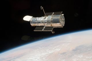 The Hubble Space Telescope is seen in orbit above the Earth as photographed from the space shuttle in May 2009.