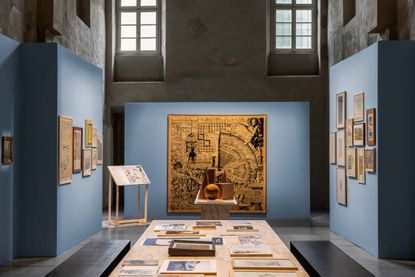 Antique Italian church with blue partitions to show framed drawings by architect Aldo Rossi