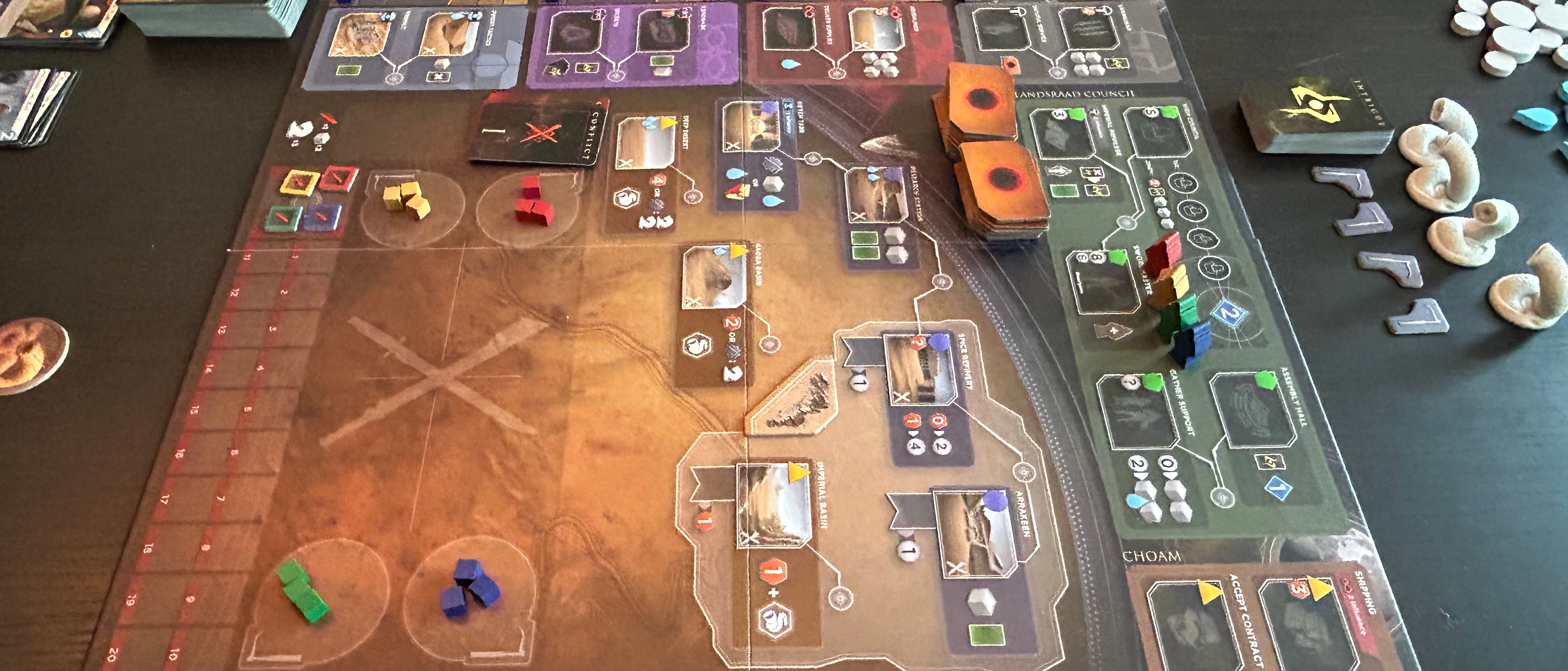 Dune: Imperium - Uprising board, tokens, and cards on a dark surface