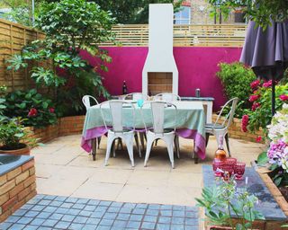 outdoor kitchen with pink feature wall designed by Ali Paterson