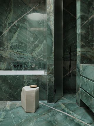 bathroom with green stone bath and shower