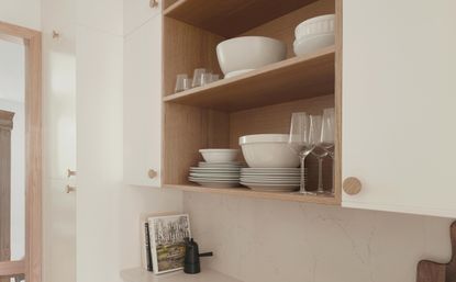 dishes on an open shelf in a kitchen