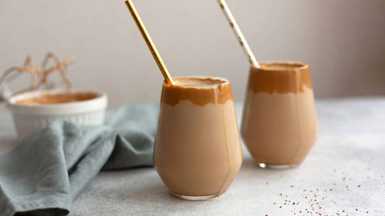 how to make coffee smoothies: two glasses of coffee smoothie with straws in