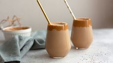 how to make coffee smoothies: two glasses of coffee smoothie with straws in