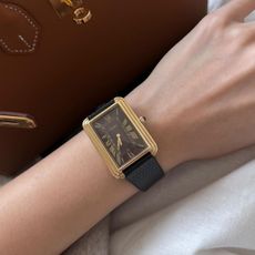 An image of influencer @savinachow wearing a vintage Cartier Tank watch.