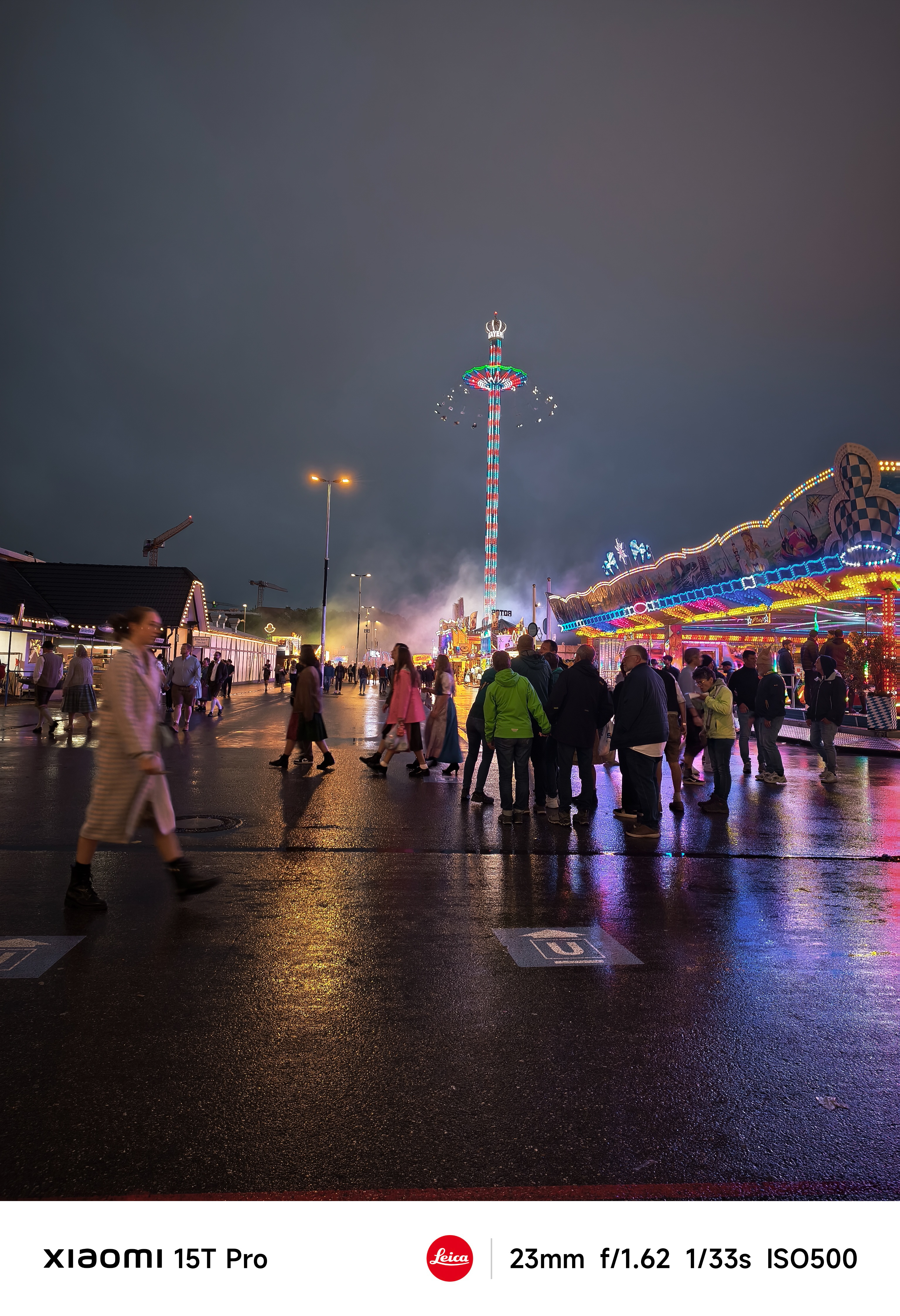 A fun fair lit up colourfully at night