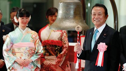 Japanese finance minister Taro Aso rings the opening bell at the Tokyo Stock Exchange © KIMIMASA MAYAMA/EPA-EFE/Shutterstock