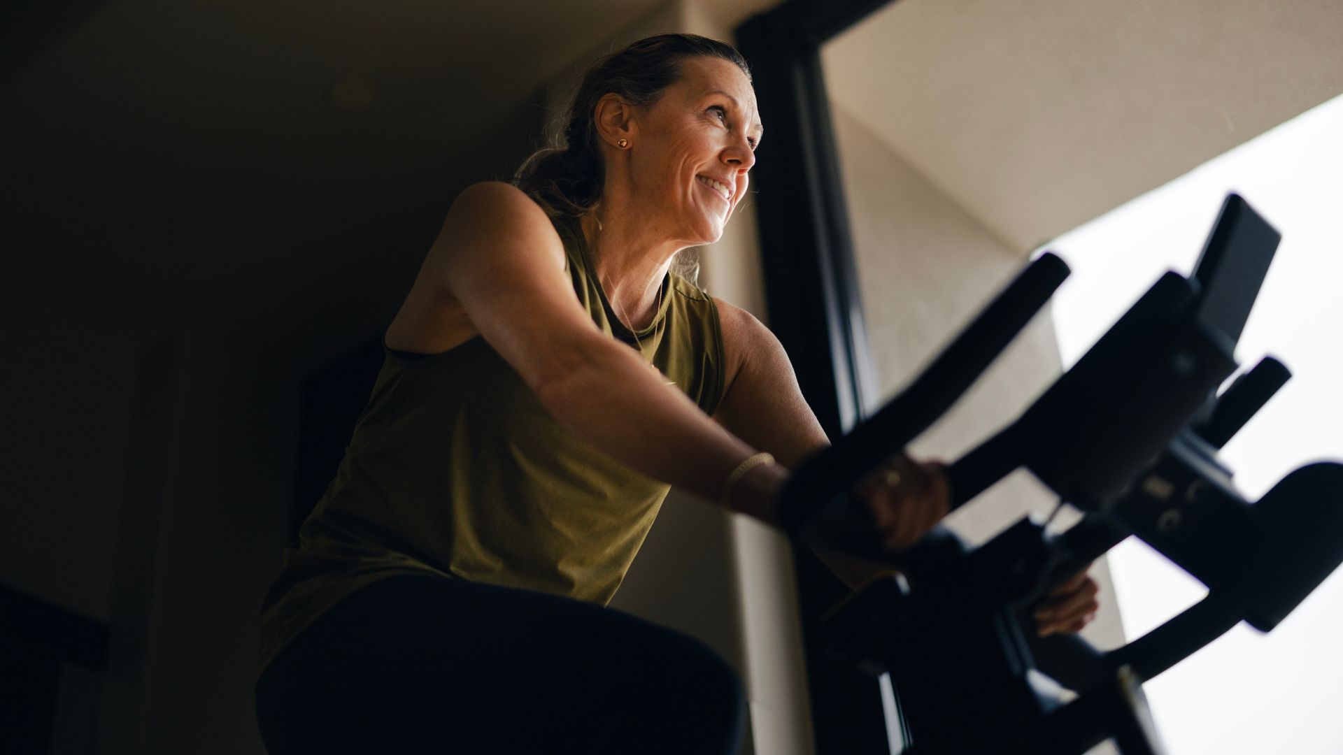 Woman doing cycling workout, smiling