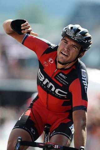 Greg Van Avermaet finds just enought energy to throw his arm up in celebration