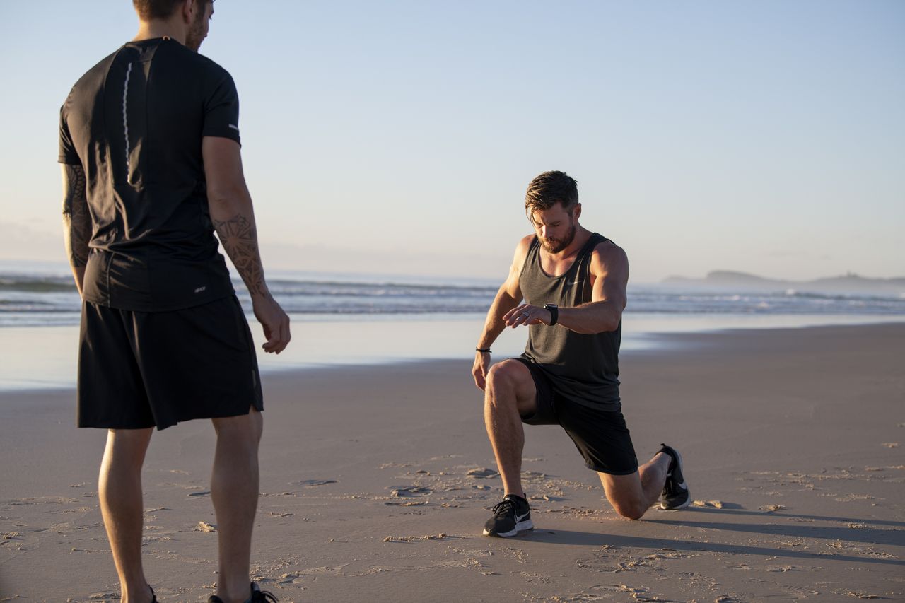 Thor actor Chris Hemsworth training on a beach 