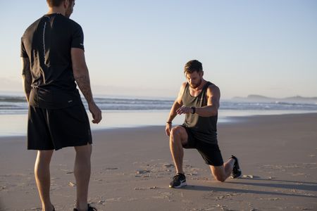 Thor actor Chris Hemsworth training on a beach 