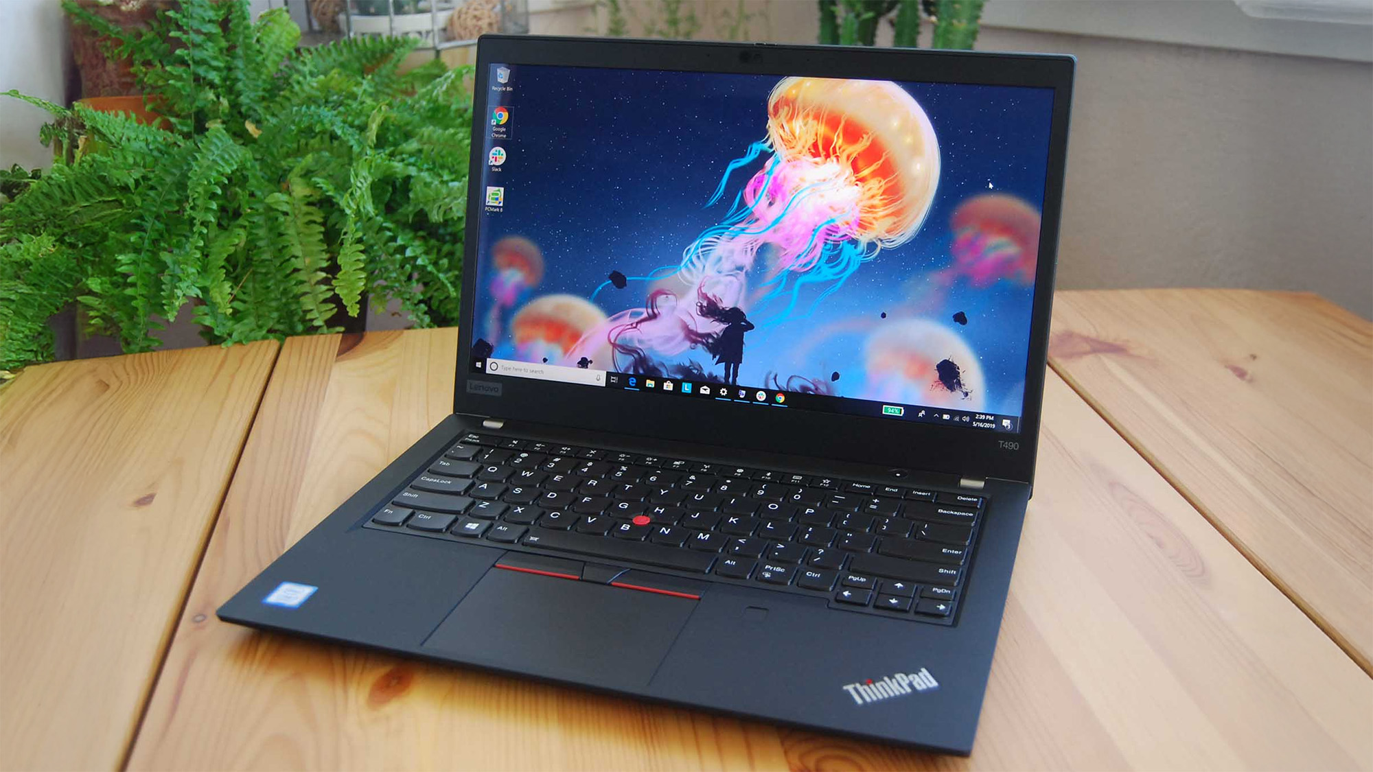 Lenovo ThinkPad T490 on a wooden desk, displaying Windows 10 desktop