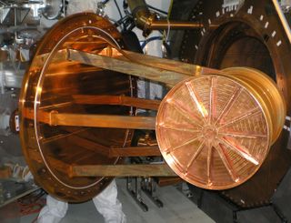 This large copper cylindrical vessel is the Enriched Xenon Observatory 200's (EXO-200) time projection chamber, the part of the detector that contains the liquid xenon, isotopically enriched in xenon-136. The photo shows the chamber being inserted into th