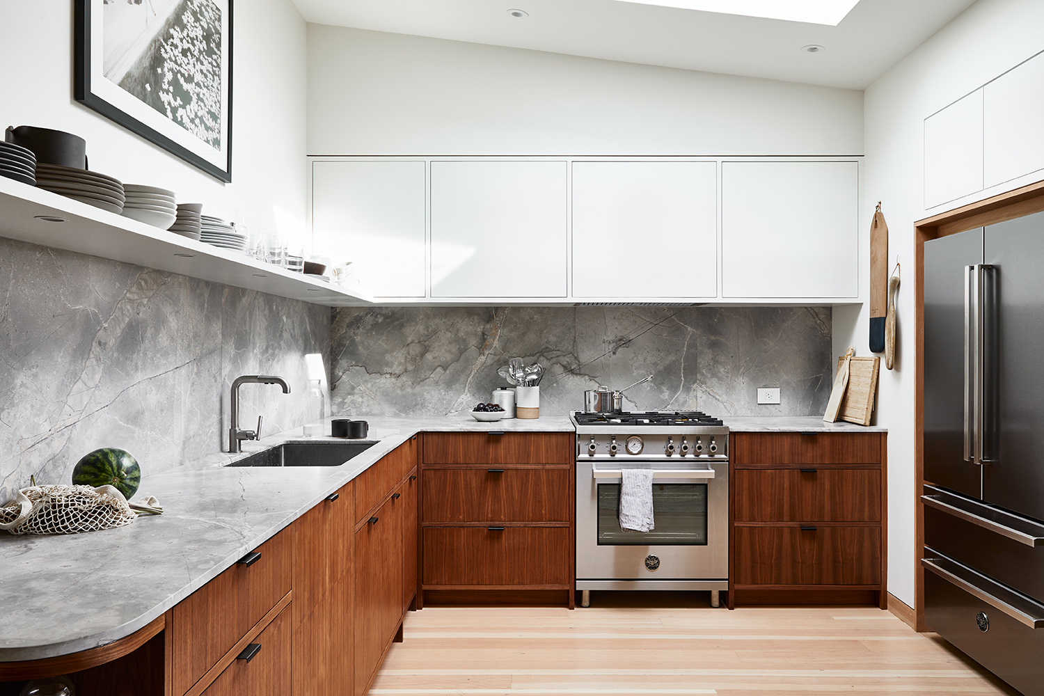 Mid century kitchen with walnut cabinets and white slab doors