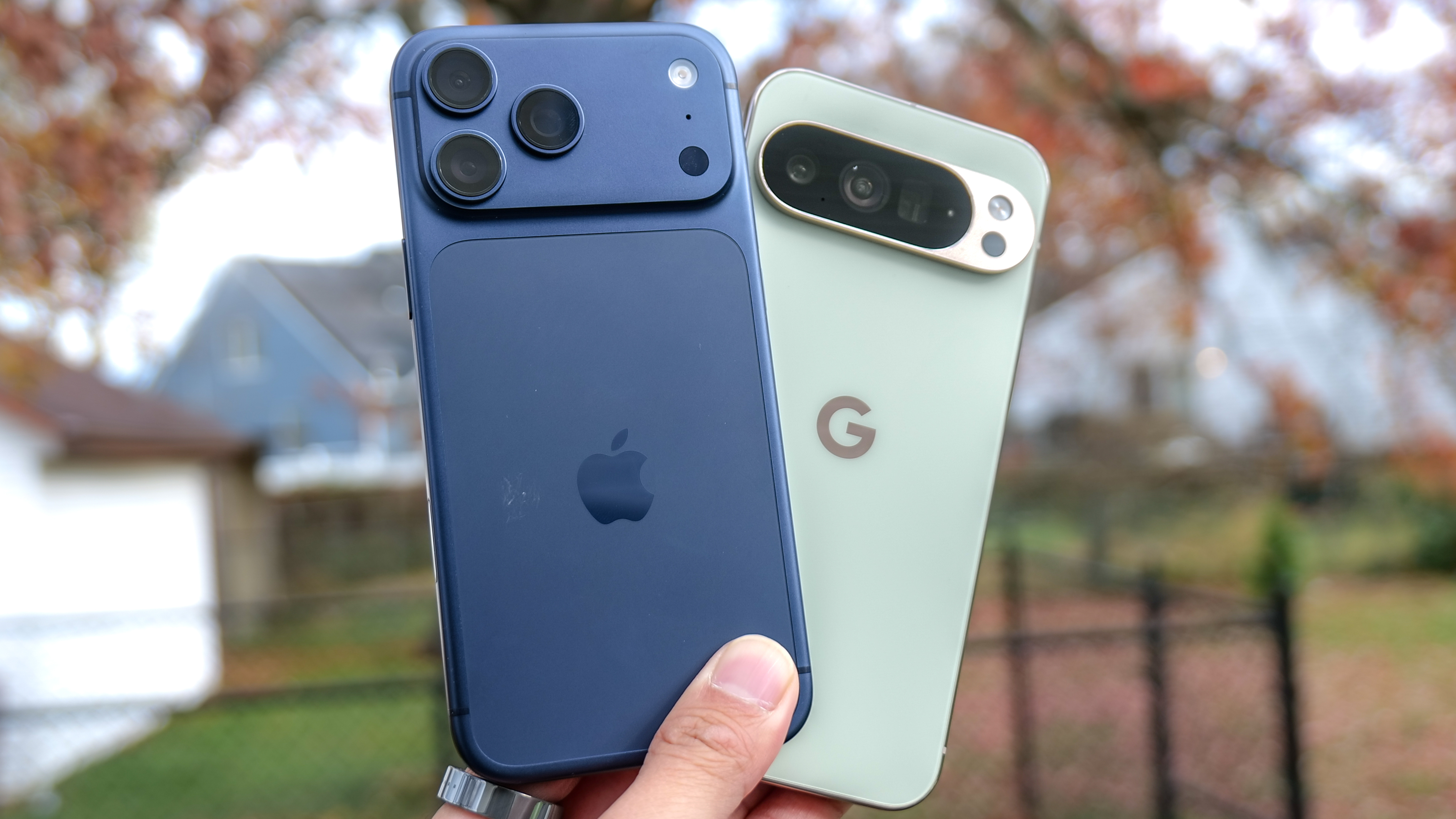 iPhone 17 Pro Max vs Pixel 10 Pro XL held in the hand.
