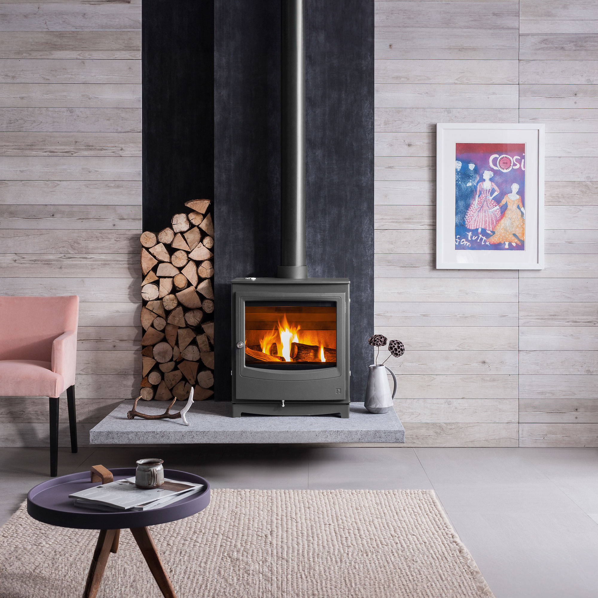 modern log burning stove on raised stone hearth
