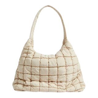 A cream coloured puffer shoulder bag on a white background.
