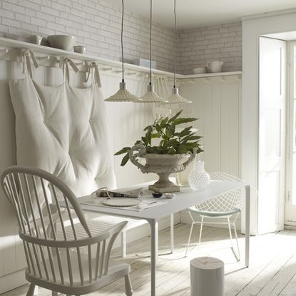 dinning table with chair white walls and wooden flooring