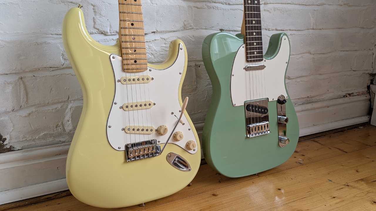 A Fender Player II Stratocaster and Telecaster leaning against a white brick wall