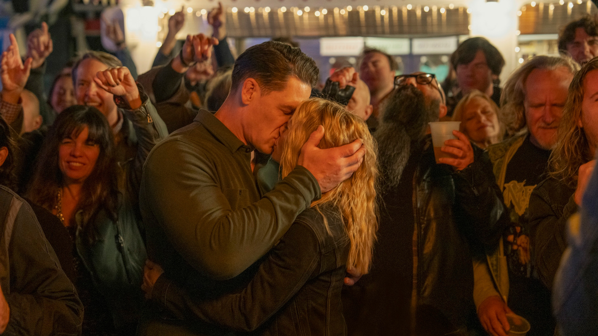 Peacemaker (John Cena) and Harcourt (Jennifer Holland) kiss in the Peacemaker season 2 finale.