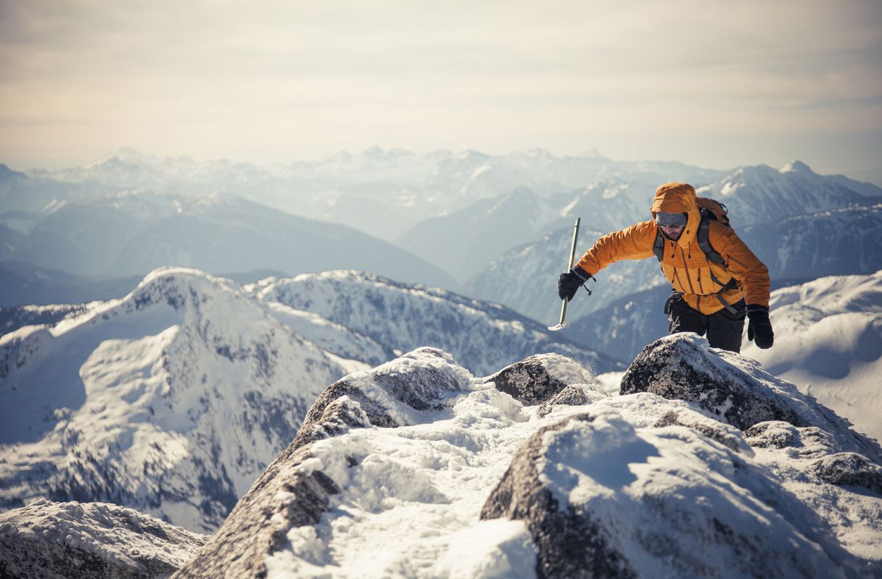 A mountaineer approaches the summit of a mountain in the Coquihalla Recreation Area of British Columbia, Canada.