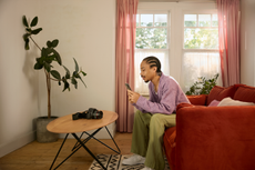 A man sitting on his sofa, ordering items from eBay