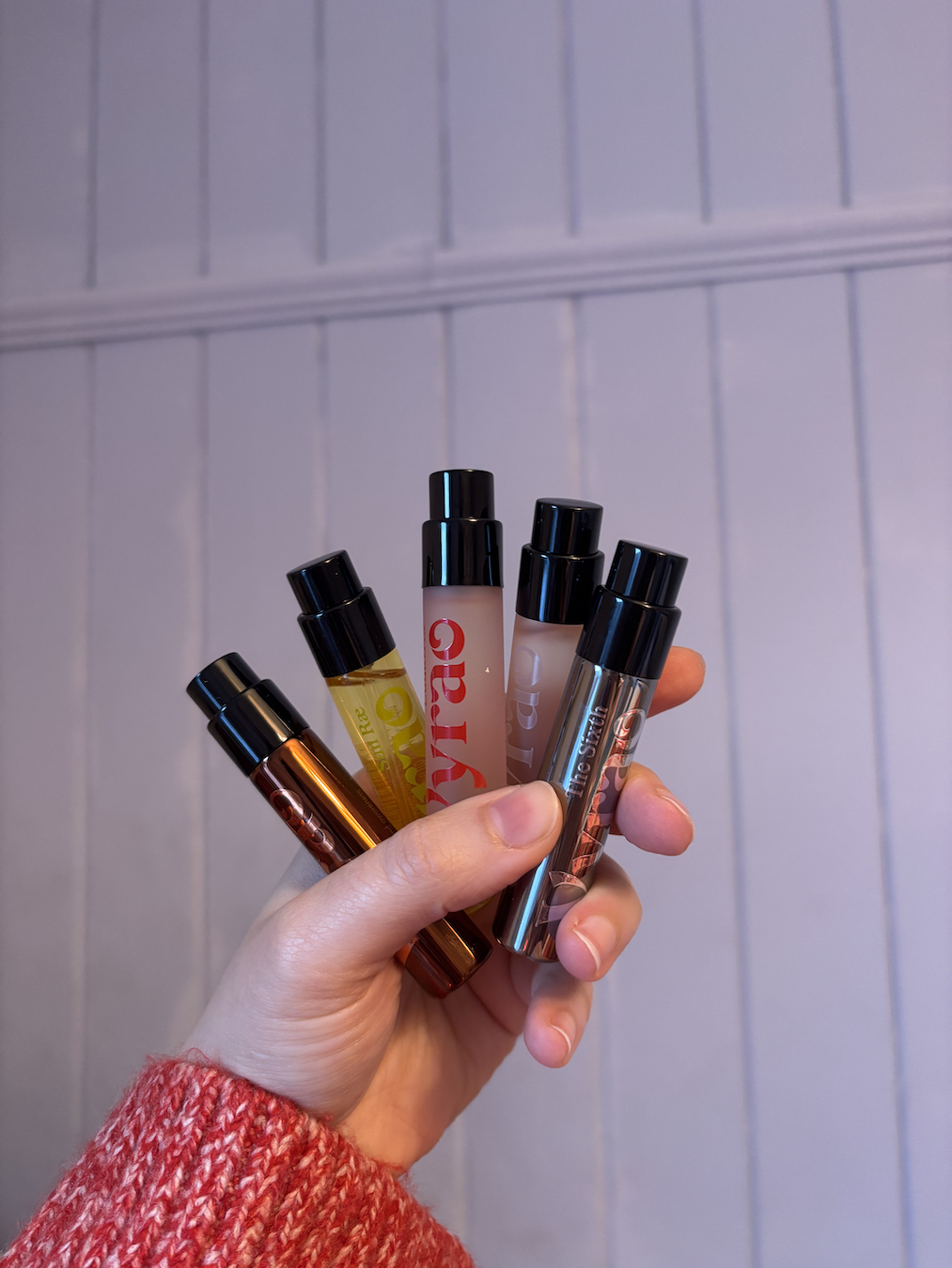 Mica Ricketts holding selection of best Vyrao perfumes