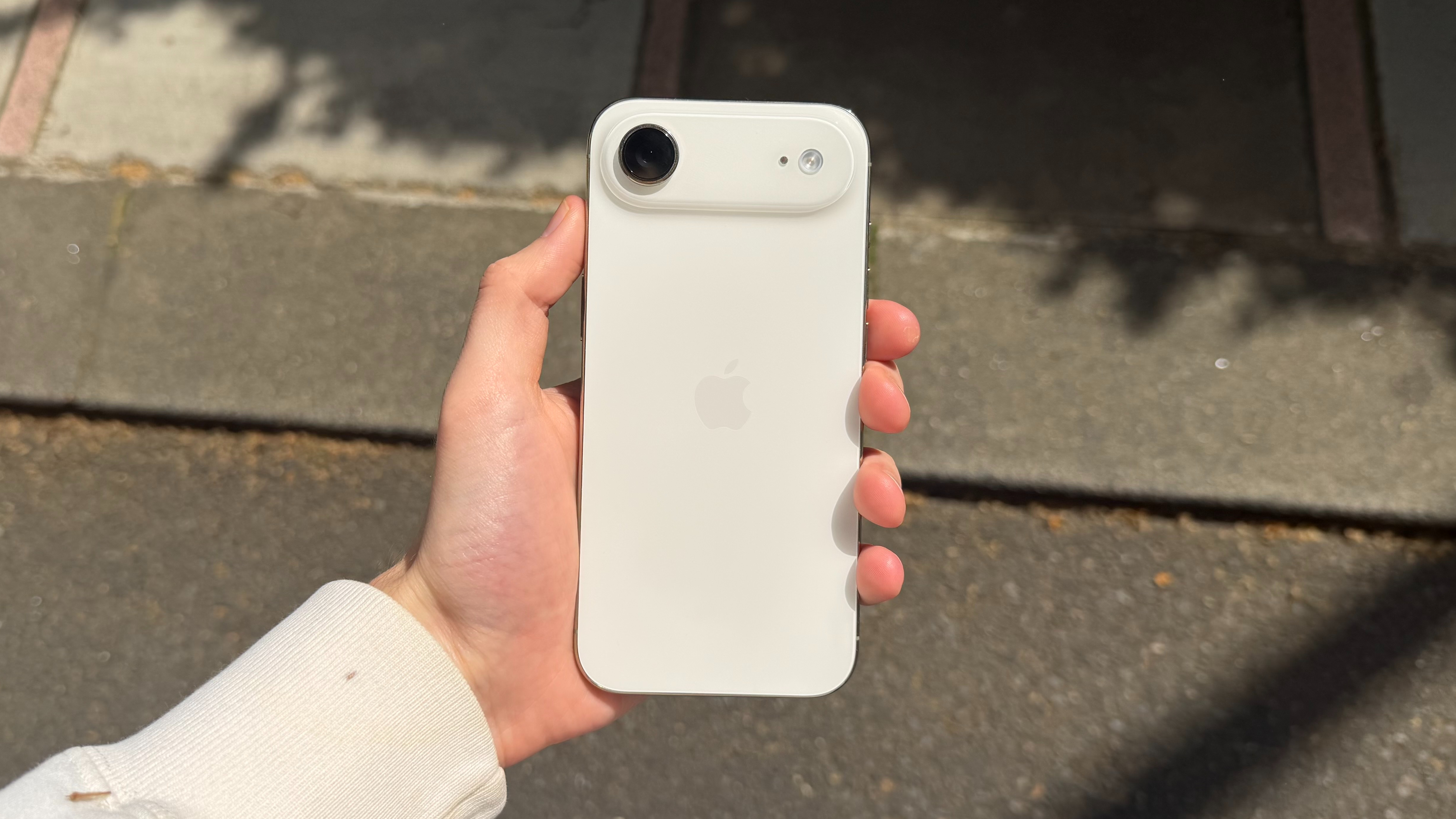 The iPhone Air being held in the hand outside